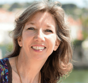 Headshot of Andrea Caprio smiling with medium brown hair